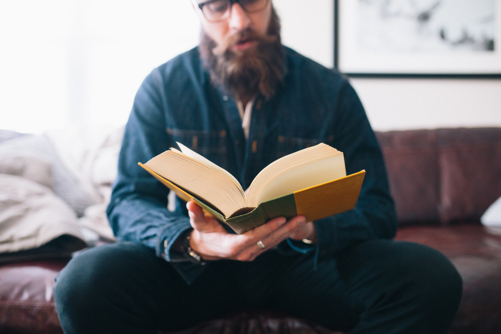 man reading a big book