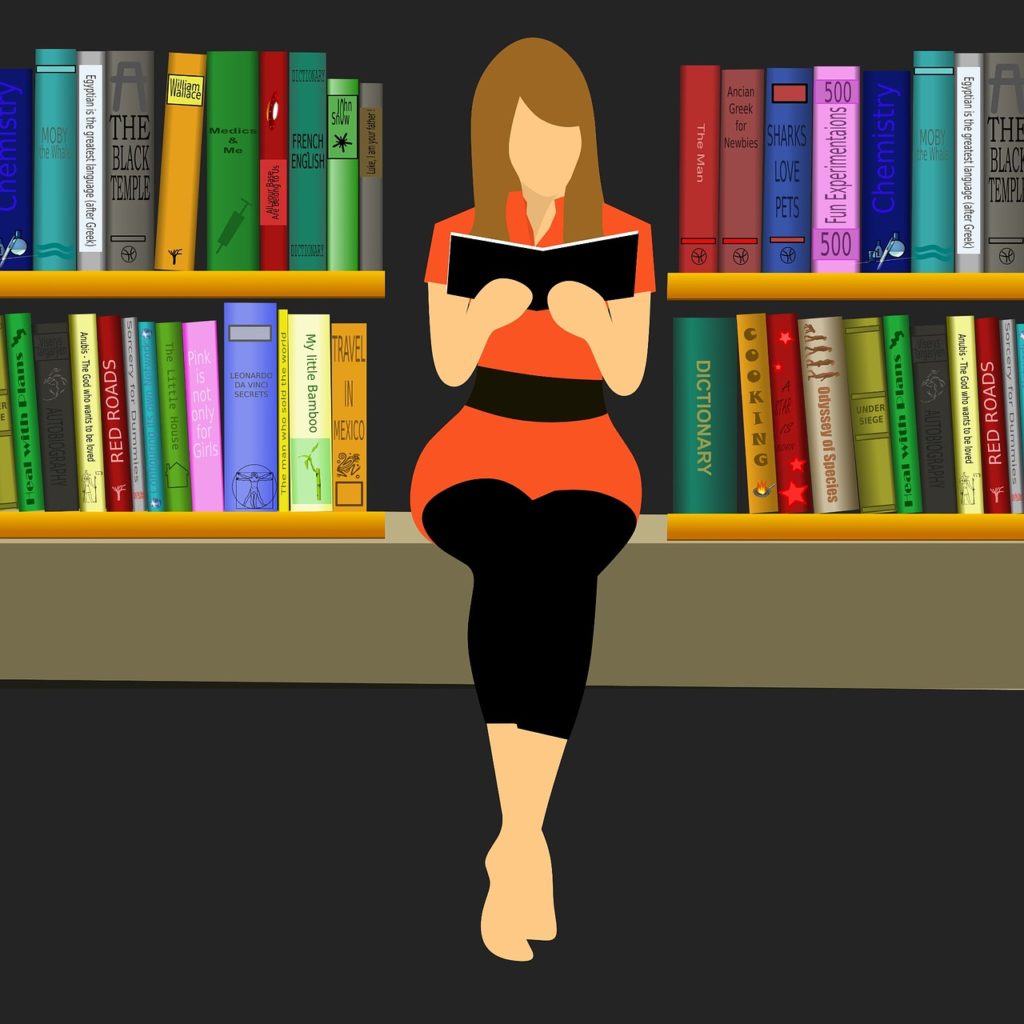 woman sitting & reading in front of book shelves