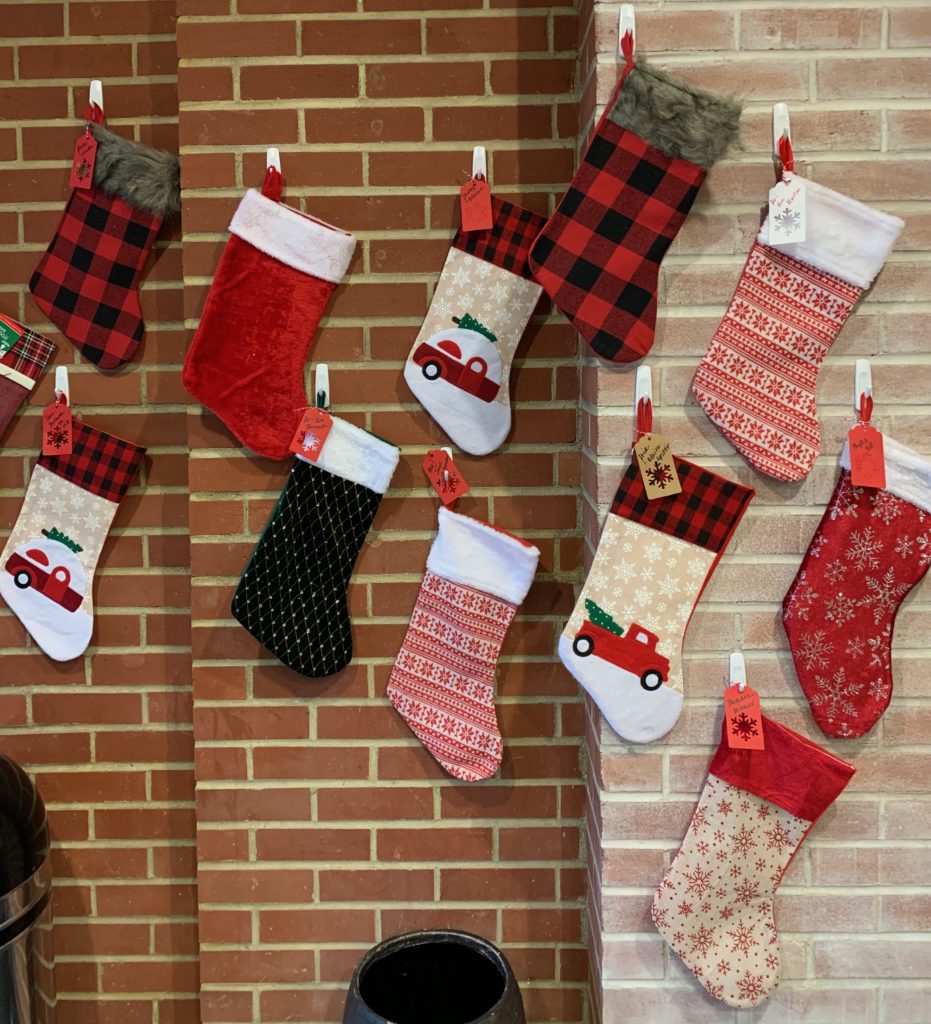 several Christmas stockings hung on wall