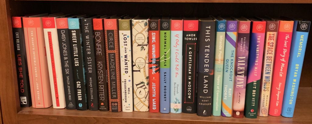 a shelf filled with upright hardcover books