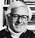 headshot: smiling man with white hair, wearing glasses