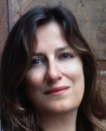 Head shot: A white woman with long brown hair.