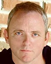 Headshot of author Dennis Lehane, a white, middle-aged man